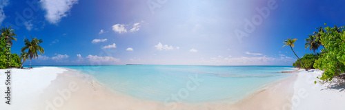 Panorama of Beach at Maldives island Fulhadhoo with white sandy idyllic perfect beach and sea and curve palm