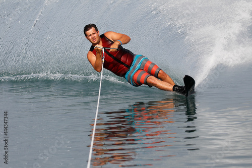 A slalom waterskier turning hard photo