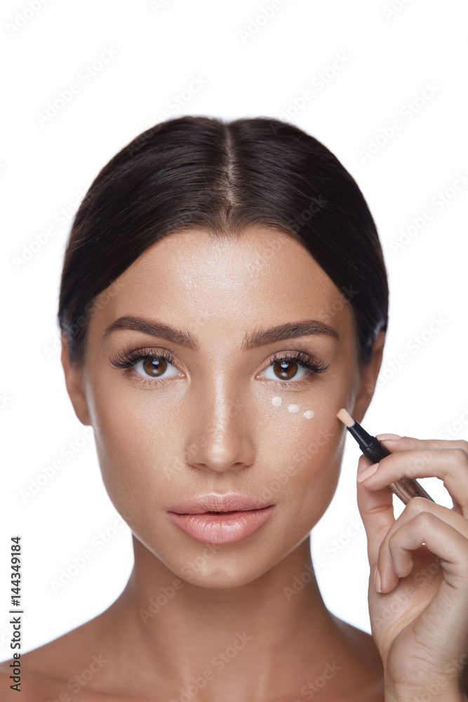 Beauty Woman Face Makeup. Female Applying Corrector Under Eyes