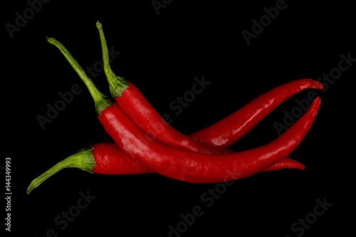 heap of red chili pepper isolated on black
