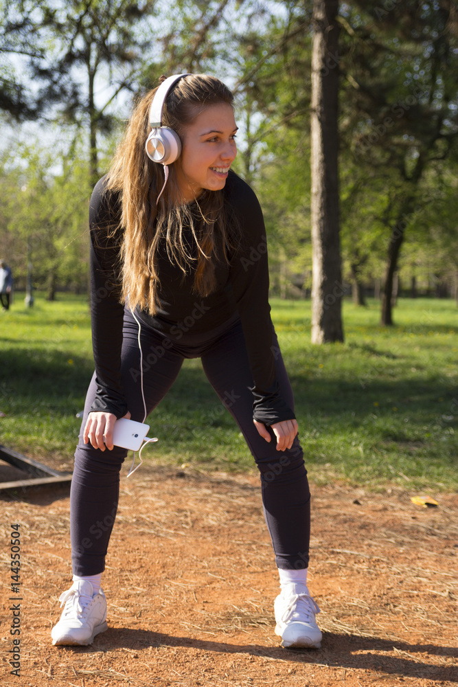Young pretty girl doing exercise and running in the park Young pretty girl doing exercise and running in the park