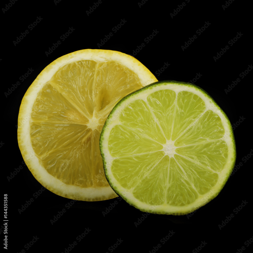 lime and lemon slices on black background isolated lime and lemon slices on black background isolated