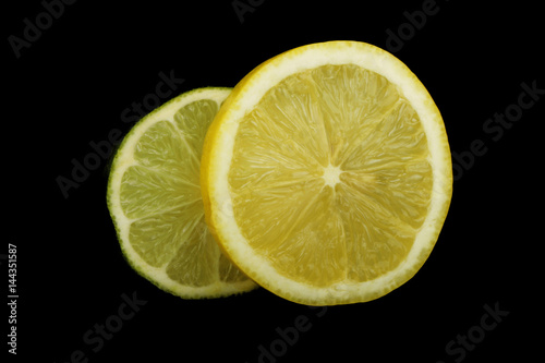 Photos lime and lemon slices on black background isolated