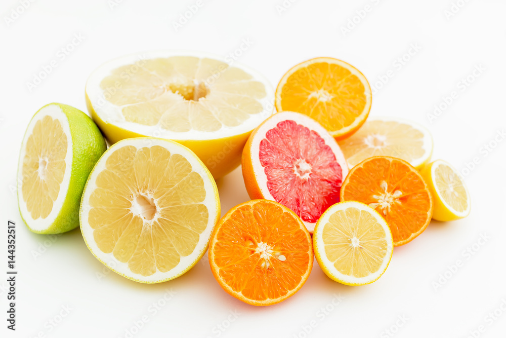 Fruit background. Sliced citrus fruits on white background. Flat lay, top view. Fruit background. Sliced citrus fruits on white background. Flat lay, top view.
