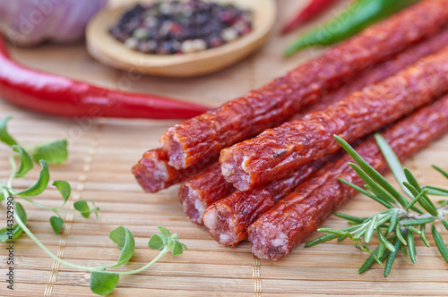 Snack stick sausage on a bamboo mat