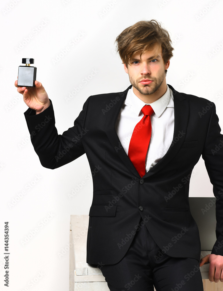 Caucasian stylish business man posing with perfume Caucasian stylish business man posing with perfume
