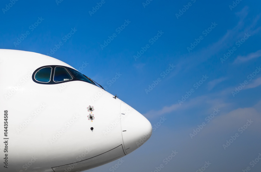 Nose and cockpit of pilots aircraft on a background of blue clear sky