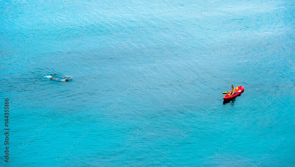 July 17, 2016 - Koh Tao, Thailand : A man snorkeling toward his friend on kayak.