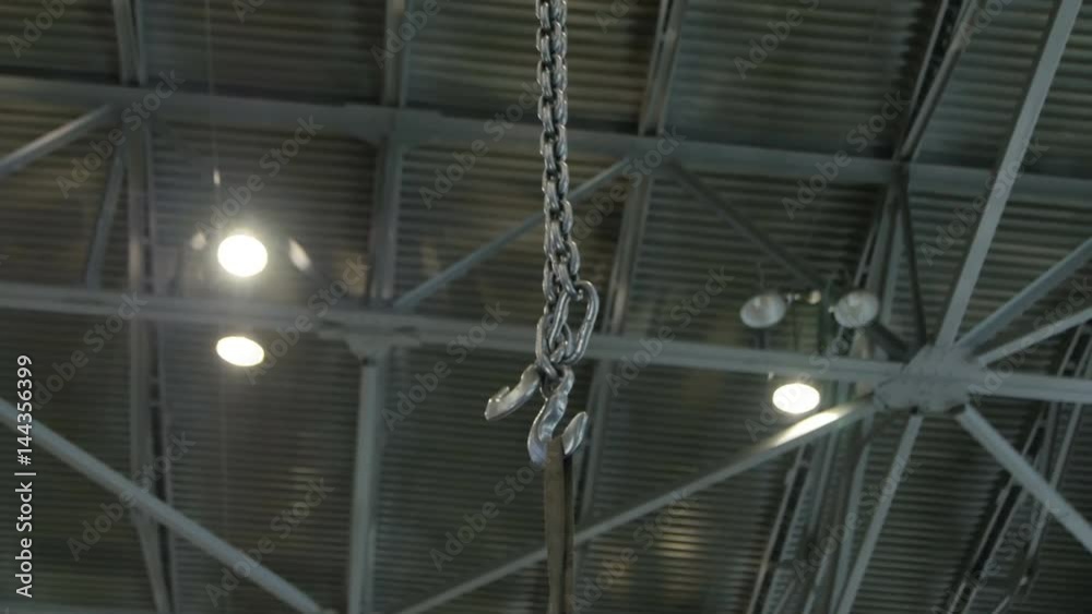 Closeup Long Metal Chain with Cargo on Large Hook Closeup Long Metal Chain with Cargo on Large Hook
