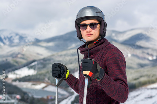 Skier in a glasses and a helmet in the mountains