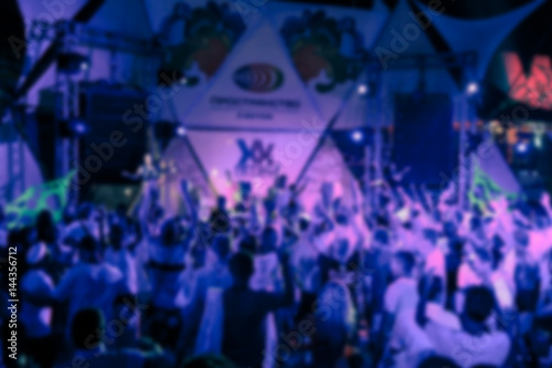 Blurry night club dj party people enjoy of music dancing sound with colorful light. club night light dj party Ibiza club. With Smoke Machine and lights. Dark background. © Alexey Lesik