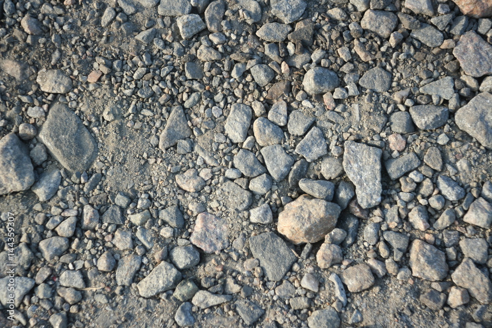 Crushed grey stone on the ground texture background Crushed grey stone on the ground texture background