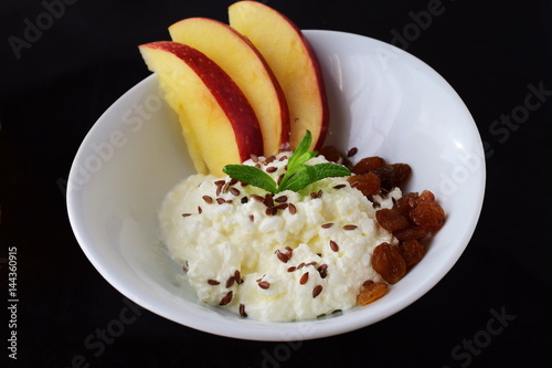 Healthy breakfast: cottage cheese with flax seeds, raisins, fresh apples. Healthy eating concept photo