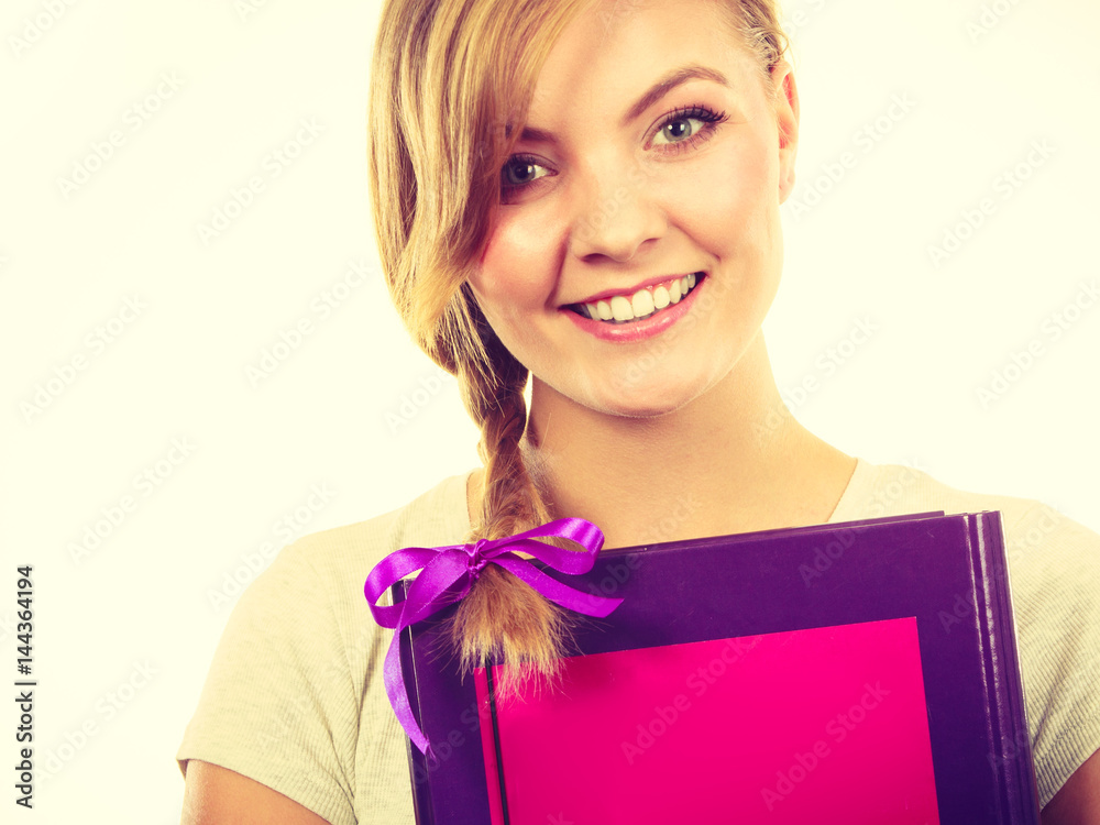 Young teenage student with braid holding books Young teenage student with braid holding books