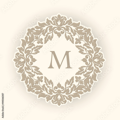 Vector round floral and geometric monogram frame on light yellow background. Monogram design element. Vintage styled initial decoration.