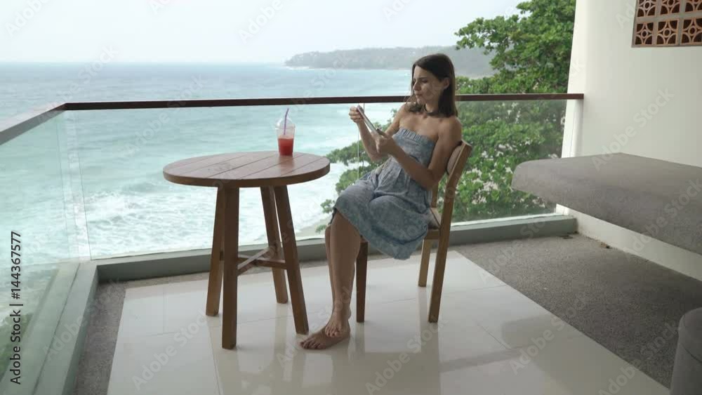 custom made wallpaper toronto digitalYoung woman browsing Internet on tablet computer sitting on terrace
