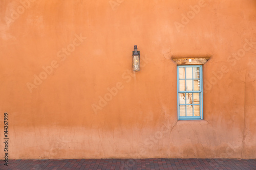 orange wall with turquoise window in Santa Fe, New Mexico photo