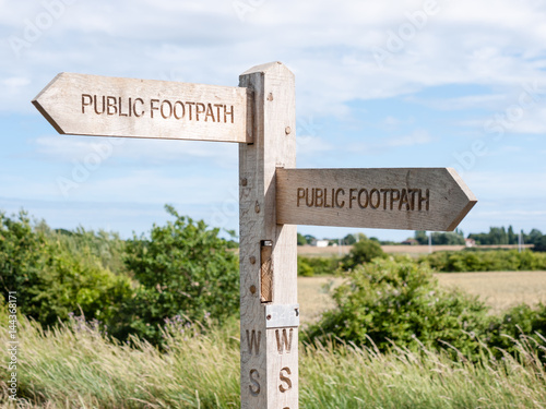 Public footpath sign in the UK giving directions of the path.