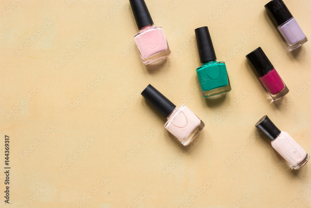 hands care concept with nail polish orange desk background top view mock-up