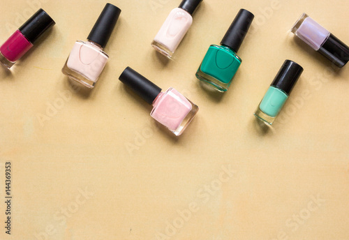 hands care concept with nail polish orange desk background top view mock-up