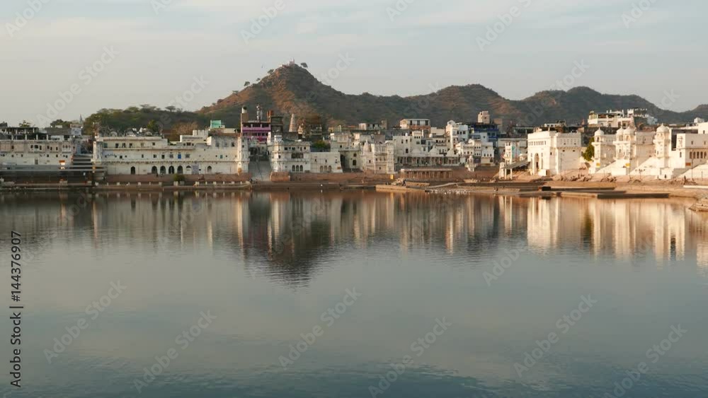 The holy ghats on water pond in Pushkar, Rajasthan, India, sacred town for hindu people. Sunset view. The holy ghats on water pond in Pushkar, Rajasthan, India, sacred town for hindu people. Sunset view.