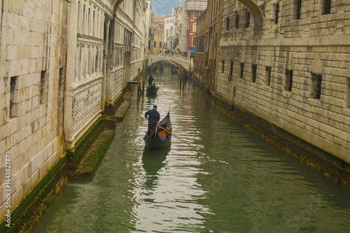 scene with traditional gondola and canal in Venice, Italy
