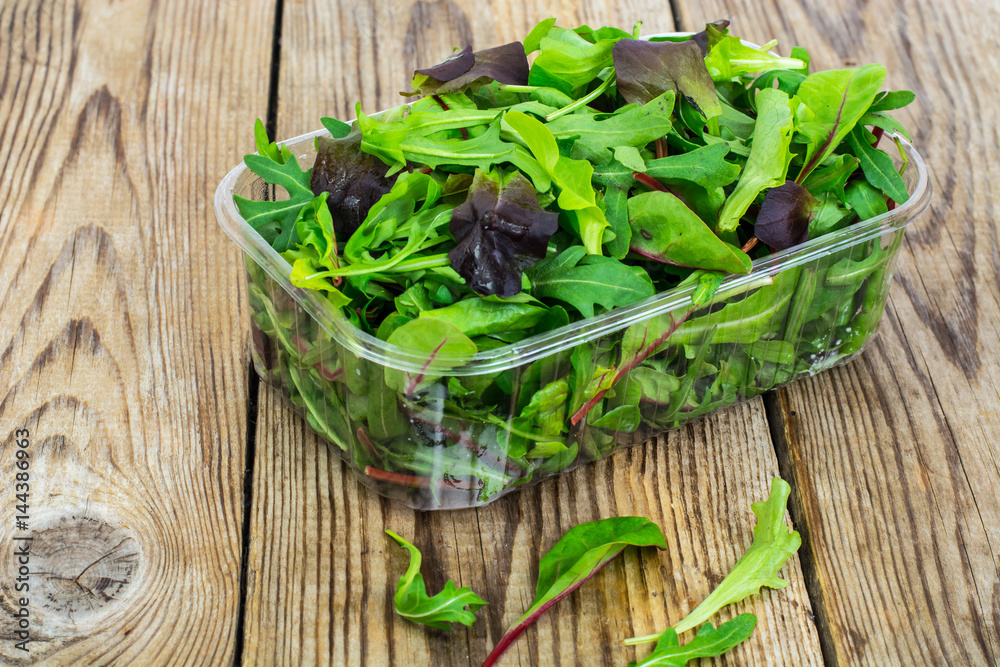Healthy eating of arugula, mitsuna, chard, red mustard in plasti Healthy eating of arugula, mitsuna, chard, red mustard in plasti