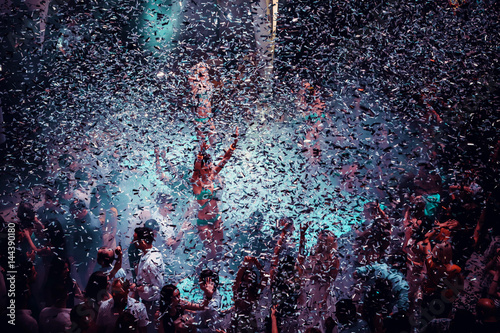 Night club dj party people enjoy of music dancing sound with colorful light with Smoke Machine and lights show. Hands up in the earth.