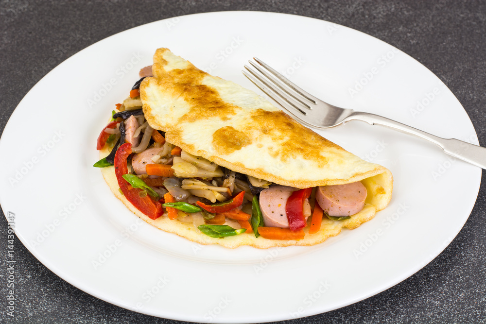 Breakfast omelet with vegetables and sausages Breakfast omelet with vegetables and sausages