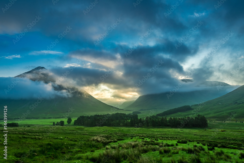 Foggy sunset over the mountains of Glencoe in Scotland