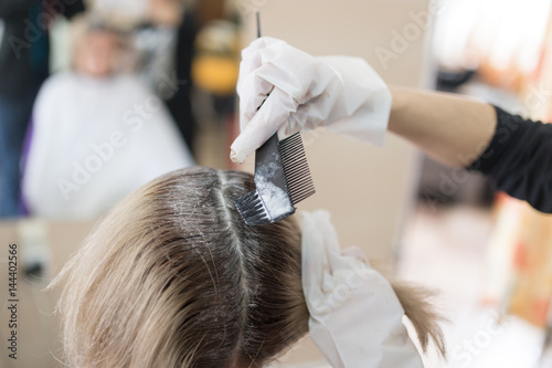 Hair coloring girl in the beauty salon