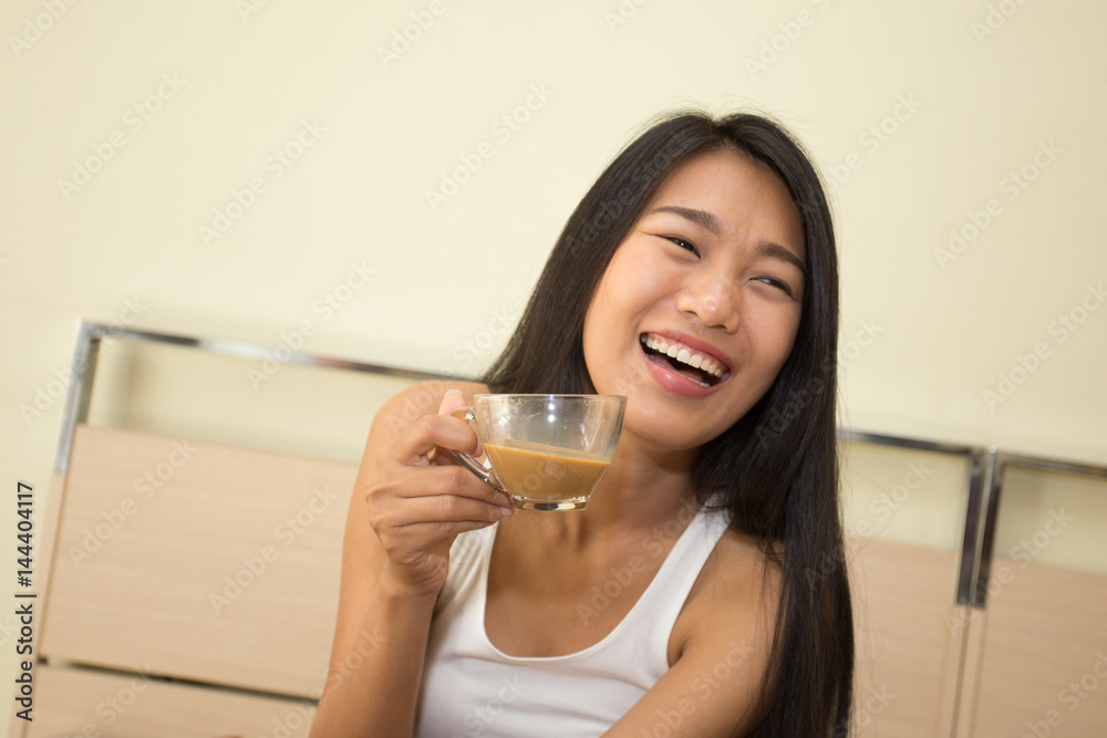 Beautiful asian woman with attractive smile while drinking coffee, Young woman portrait in bedroom. Beautiful asian woman with attractive smile while drinking coffee, Young woman portrait in bedroom.