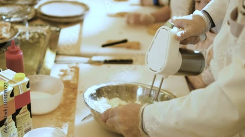 Handsome confectioner in chef uniform producing ice cream with ice cream machine 4k