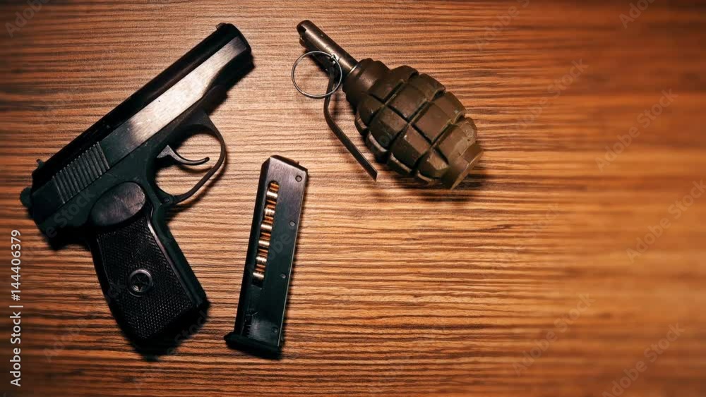 The weapon lies on the table: a cannon, a grenade, handcuffs, clips, bullets The weapon lies on the table: a cannon, a grenade, handcuffs, clips, bullets