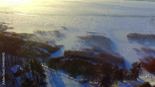 Drone flight over the snowy frozen lake photo