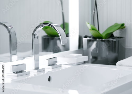 close up view of nice metal faucet in modern bathroom photo