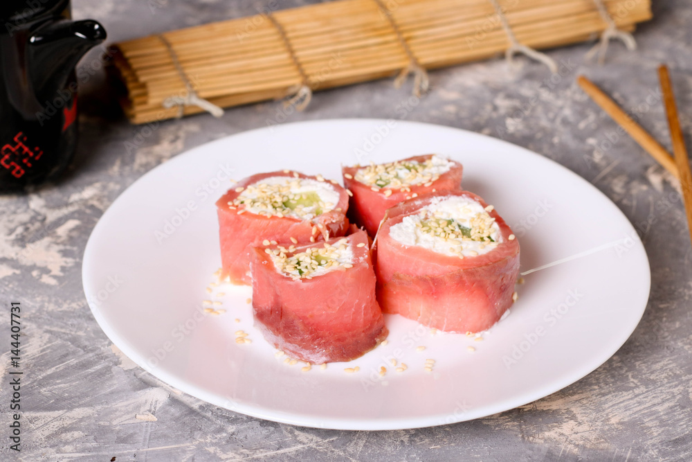 Finger food. Rolls of salmon with cream cheese close-up on the table horizontal Finger food. Rolls of salmon with cream cheese close-up on the table horizontal