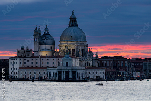 View on Grand Canal and Santa Maria della Salute basilica at sunset in Venice, Italy