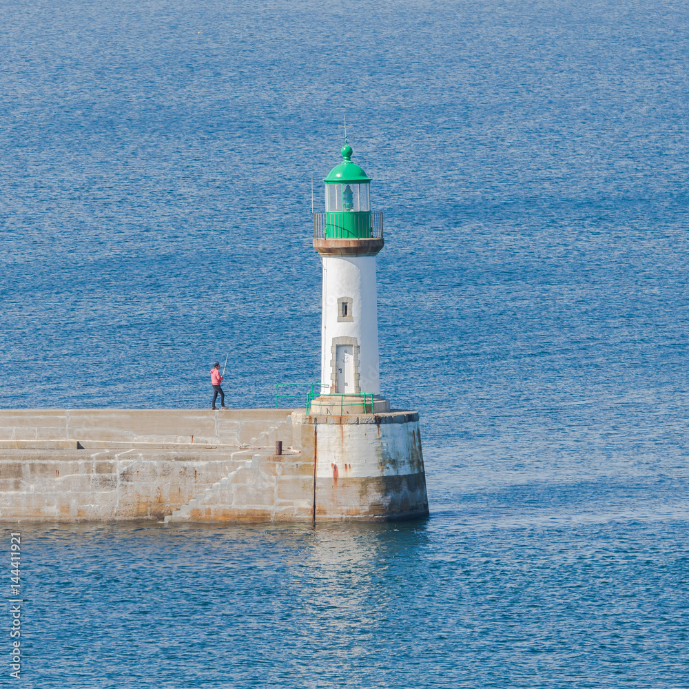 Brittany, ile de Groix, harbor Port-Tudy, green lighthouse and a angler on the quay