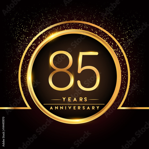 eighty five years birthday celebration logotype. 85th anniversary logo with confetti and golden ring isolated on black background, vector design for greeting card and invitation card.