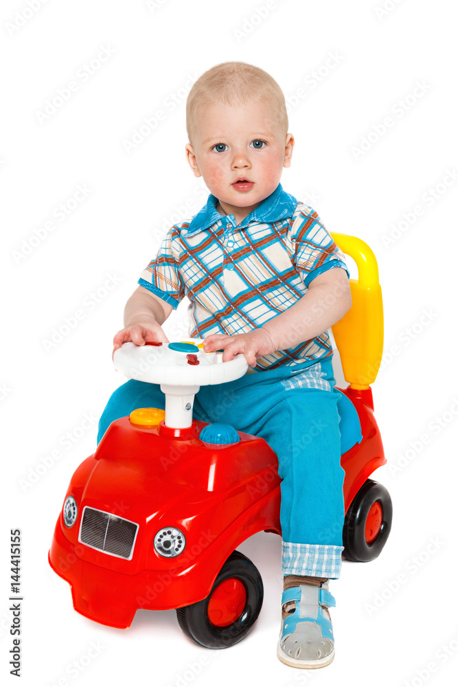 Portrait of a child with a toy on a white background. Little boy with a wooden car Portrait of a child with a toy on a white background. Little boy with a wooden car