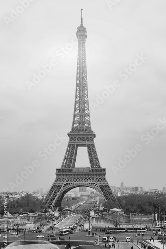 The Eiffel tower is one of the most recognizable landmarks in the world under sun light selective focus Black and white