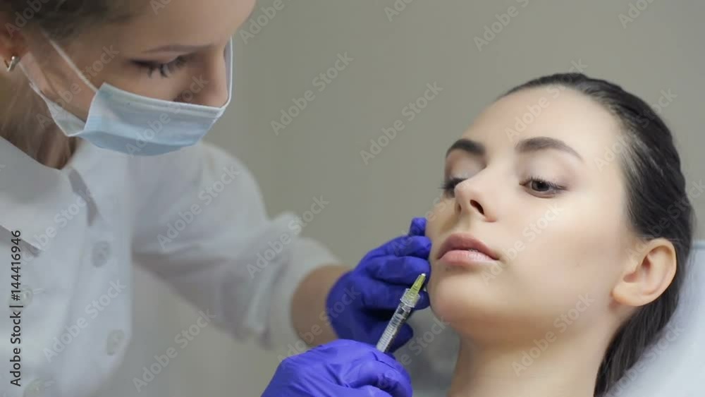 Doctor making injection in lips Doctor making injection in lips