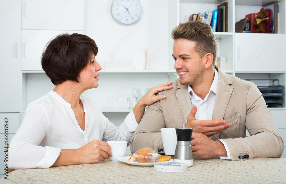 Fototapeta premium woman and man drinking tea with cakes