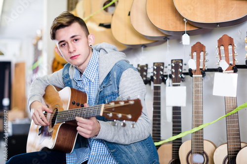 Visitor is choosing quality acoustic guitar