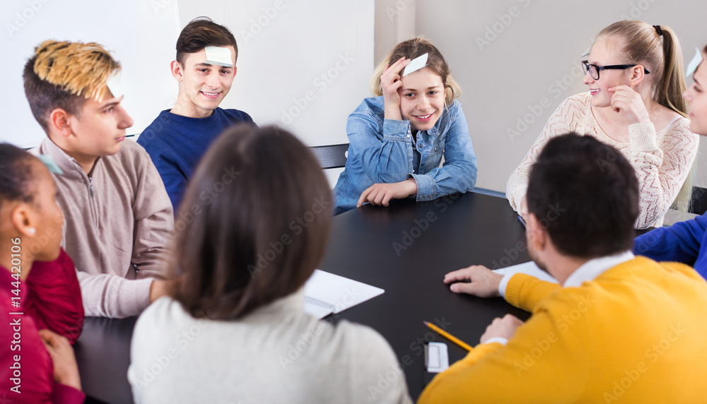 Fototapeta premium Fellow students playing guess-who game