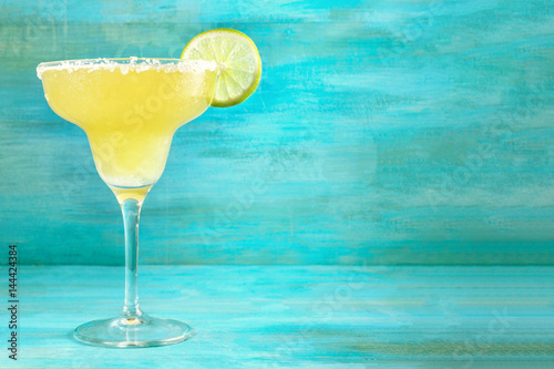 Lemon Margarita cocktails on vibrant turquoise with copyspace