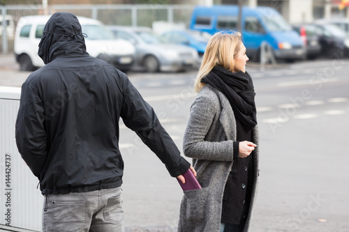 Man Stealing Purse On Street photo