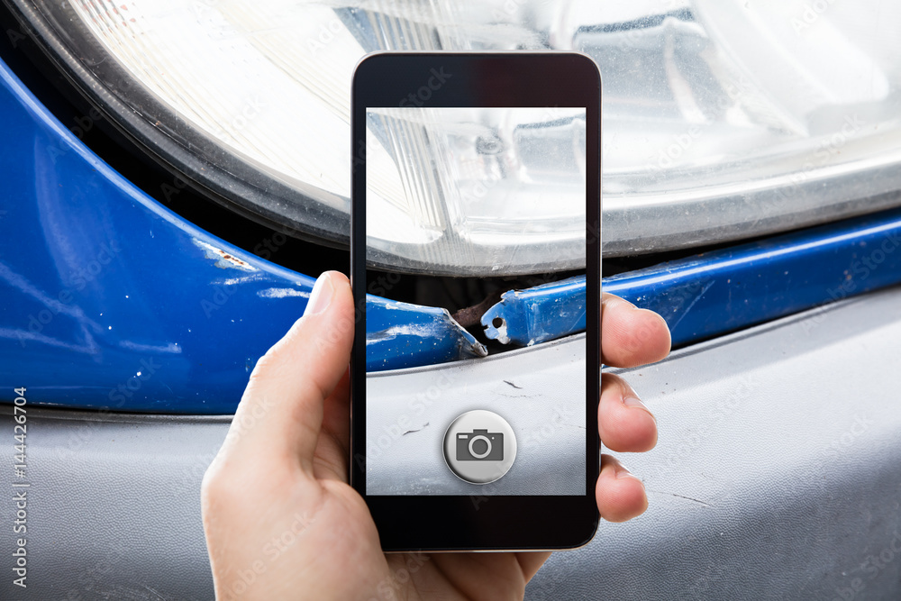 Person Taking Picture Of A Damaged Car Person Taking Picture Of A Damaged Car