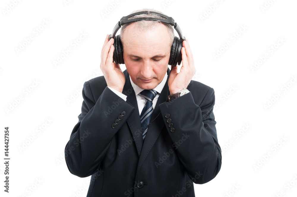 Portrait of senior elegant man holding headset Portrait of senior elegant man holding headset